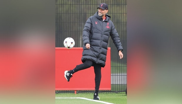 Liverpoolu2019s German manager Jurgen Klopp kicks a ball as he takes a team training session at the AXA Training Centre in Liverpool yesterday, on the eve of the UEFA Champions League match against Rangers. (AFP)
