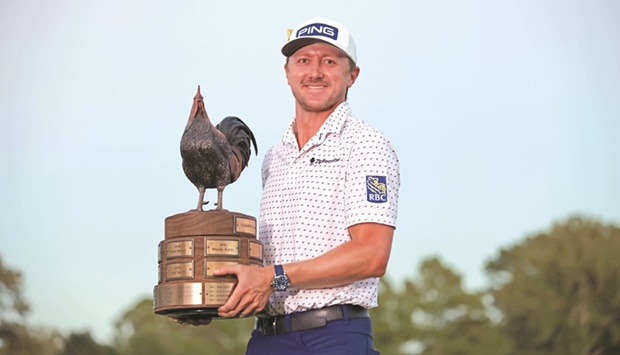 Mackenzie Hughes of Canada poses with the trophy after winning on the second play-off hole against Sepp Straka of Austria on the 18th green during the final round of the Sanderson Farms Championship at The Country Club of Jackson in Jackson, Mississippi. (AFP)