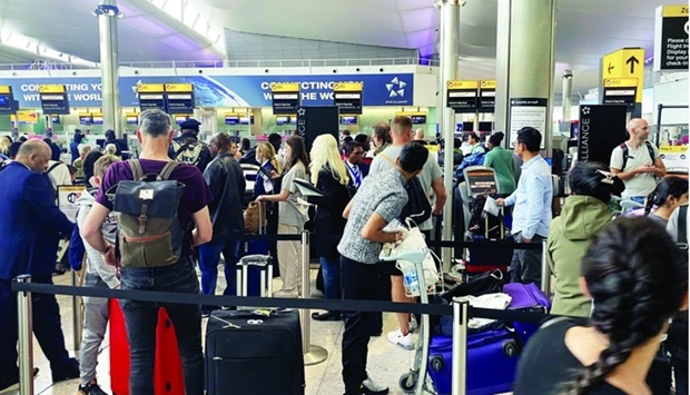 Passengers queue to check-in at terminal 2 at Heathrow Airport. Takeoff and landing slot rules at airports around the world are again in the spotlight as the aviation industry recovers from the worst crisis triggered by the Covid-19 pandemic.