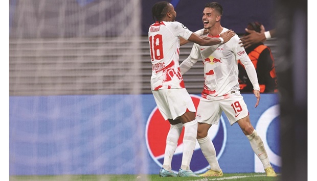 Leipzigu2019s Andre Silva (right) celebrates with Christopher Nkunku after scoring against Celtic during the UEFA Champions League Group F match in Leipzig, eastern Germany yesterday. (AFP)