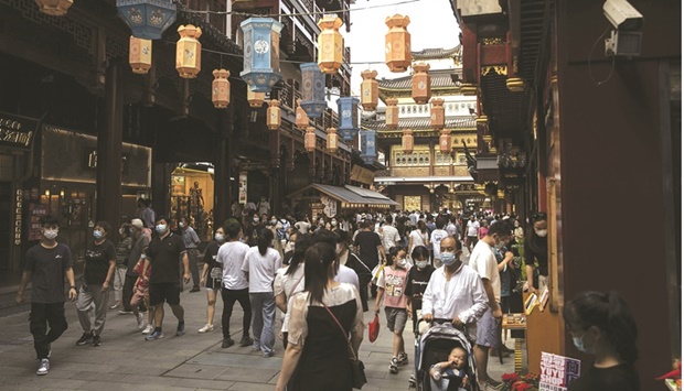 Visitors walk through the Yuyuan Garden in Shanghai. Chinese holidaymakers cut back sharply on travel and spending during the National Day break this week as strict Covid rules discouraged movement, while signs of a consumer slowdown across Asia mount.