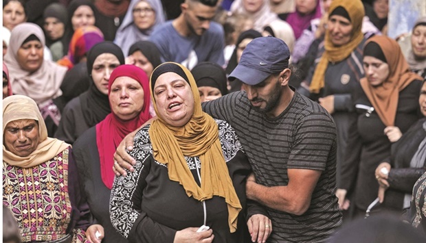 The mother of Mahdi Ladadweh, killed a day earlier in the occupied West Bank village of Al Mazraa Al Gharbiyah near the city of Ramallah, mourns his death during his funeral in the same village, yesterday.