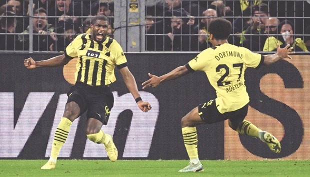 Borussia Dortmundu2019s French forward Anthony Modeste (left) celebrates after scoring against Bayern Munich during the Bundesliga match in Dortmund, western Germany, yesterday. (AFP)