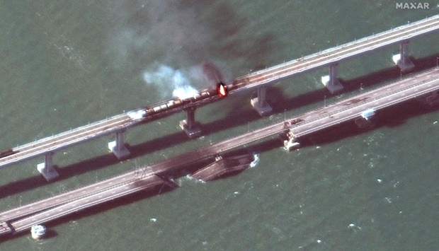 Smoke billowing from a fire on the Crimea Bridge (also known as the Kerch Bridge) that links Crimea to Russia, after a truck exploded, near Kerch. AFP PHOTO/HO/Satellite image u00a92022 Maxar Technologies.