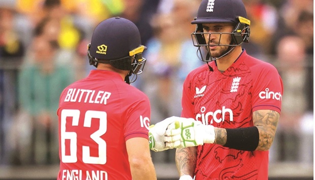 Englandu2019s Alex Hales (right) and Jos Buttler bump gloves during the first match of the Twenty20 series against Australia in Perth yesterday. (AFP)