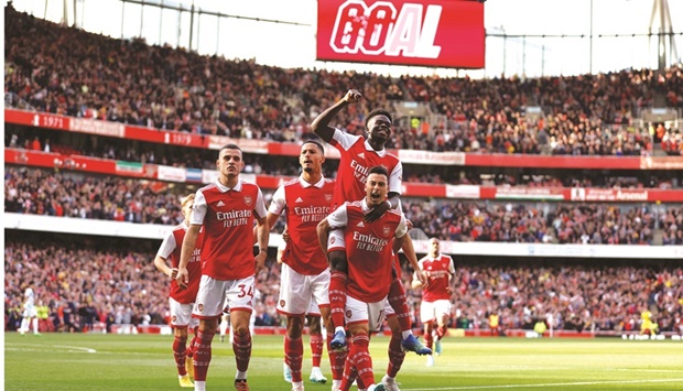 Arsenalu2019s Gabriel Martinelli (right) celebrates with Bukayo Saka and other teammates after scoring against Liverpool during the Premier League match at the Emirates Stadium in London yesterday.