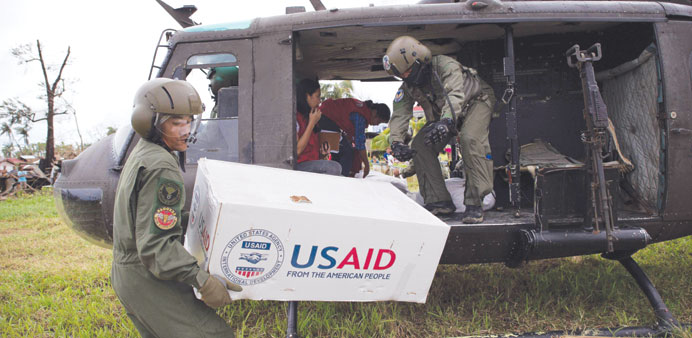 A Philippine Air Force helicopter drops relief food in La Paz yesterday.