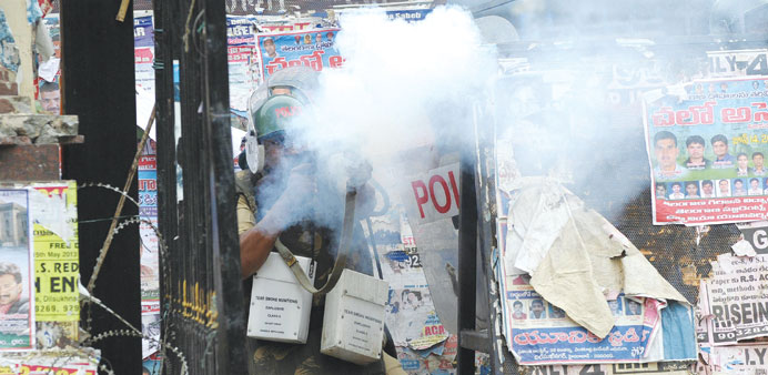 Police fire tear gas towards activists of the Telangana Joint Action Committee (TJAC) as they prevent them from marching to the assembly during a prot