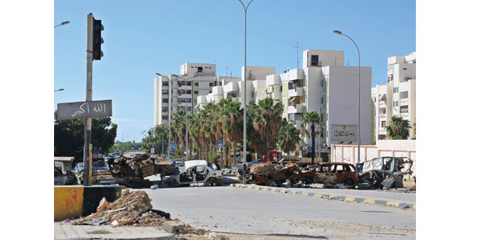 Burnt cars separate the residential area of Al Keesh from the frontline in Benghazi.