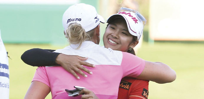 Pornanong Phatlum of Thailand (right) hugs Stacy Lewis of the US after winning the Dubai Ladies Masters golf title yesterday. (Reuters)