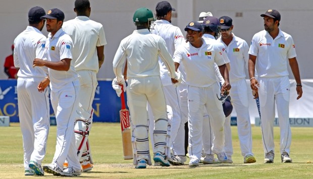 Sri Lanka's captain Rangana Herath shakes hands with Zimbabwe batsmen after winning the second test match between Sri Lanka and hosts Zimbabwe at the Harare Sports Club.