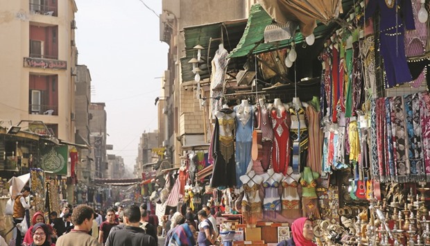 People walk around shops at the Al-Hussein and Al-Azhar districts in Cairo on Wednesday. Egypt secured $2bn in financing from international banks, a day before the International Monetary Fundu2019s board meets to consider a $12bn loan officials say will help restore investor confidence in the economy.