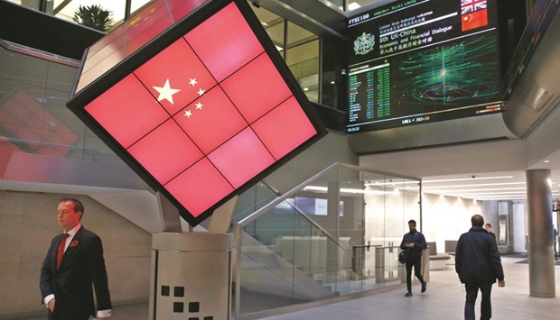 An illuminated cube bearing the Chinese flag is seen at the entrance foyer of the London Stock Exchange yesterday. London underperformed its European peers, losing over 1%, as investors fled high-dividend stocks.