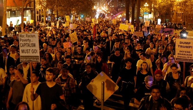Demonstrators march on Market Street in San Francisco, California, US following the election of Donald Trump as the president of the United States
