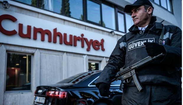 A security agent standing guard in front of the Cumhuriyet newspaper's headquarters in Istanbul. October 31, 2016 file picture