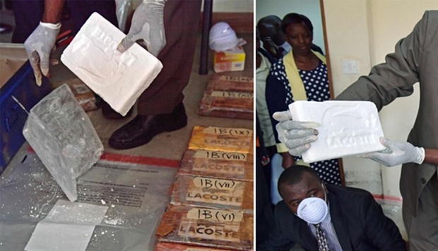 An official presents a slab of cocaine as evidence