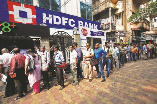 People wait to enter an HDFC bank branch in Kolkata yesterday.