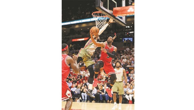Dwyane Wade (right) of the Chicago Bulls shoots as Willie Reed of the Miami Heat attempts to block during the first quarter of the NBA game at American Airlines Arena in Miami, Florida on Thursday night. (AFP)
