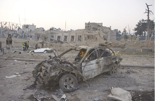 Afghan security personnel inspect the site of an attack targeting the German consulate in Mazar-i-Sharif yesterday.