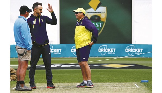 South Africa captain Faf du Plessis (centre) talks with curator Marcus Pamplin (left) and team coach Russell Domingo as they inspect the pitch at Bellerive Oval in Hobart, venue of the second Test that begins today. (Reuters)