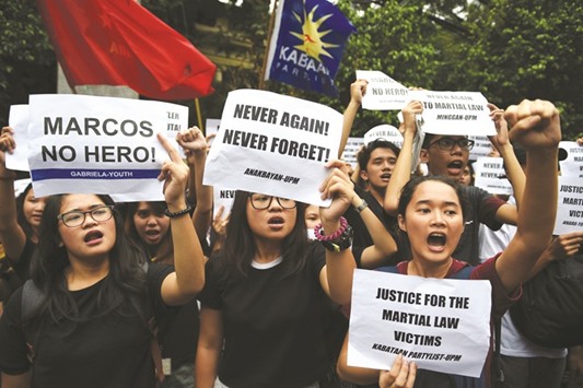 Students from the state university shout slogans during a protest in front of the Supreme Court in Manila yesterday, against the courtu2019s decision allowing the burial of the late dictator Marcos at the Heroesu2019 cemetery.