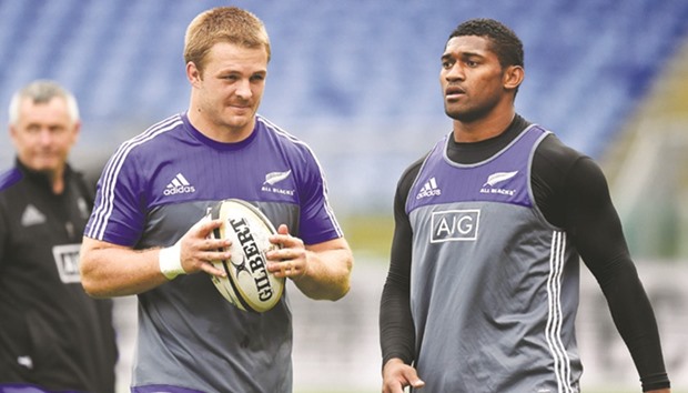 New Zealandu2019s Sam Cane (left) holds a ball next to Waisake Naholo during a training session yesterday at the Olympic Stadium on the eve of the match against Italy in Rome. (AFP)