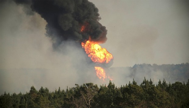Flames shoot into the sky from a gas line explosion