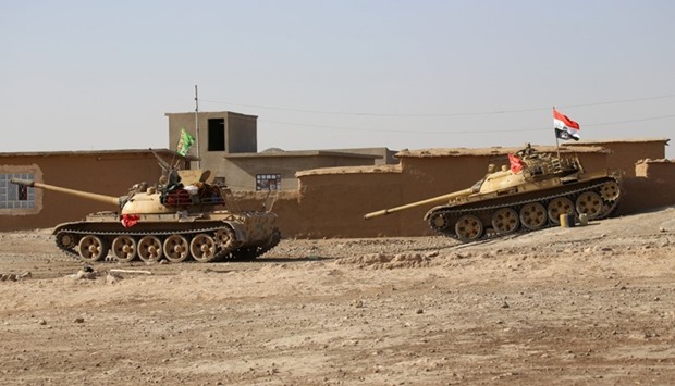 Tanks of Popular Mobilization Forces (PMF) are seen during the operation to attack Islamic State militants south of Mosul, Iraq.