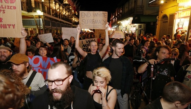 Protesters make their way down Bourbon St. as they demonstrate against the election of Republican Donald trump as President of the United States in New Orleans, Louisiana.