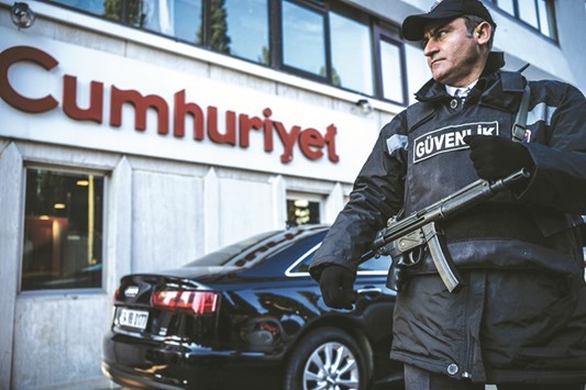 This file photo taken on October 31 shows a security agent standing guard in front of the Cumhuriyet newspaperu2019s headquarters in Istanbul.
