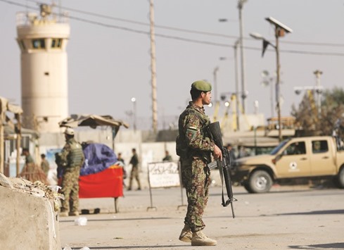 Afghan National Army (ANA) soldiers keep watch outside the Bagram Airfield entrance gate, after an explosion at the Nato air base, north of Kabul, yesterday.