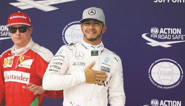 Mercedesu2019 Lewis Hamilton of Britain (R) celebrates pole position next to Ferrariu2019s Formula One driver Kimi Raikkonen of Finland in Sao Paulo yesterday.