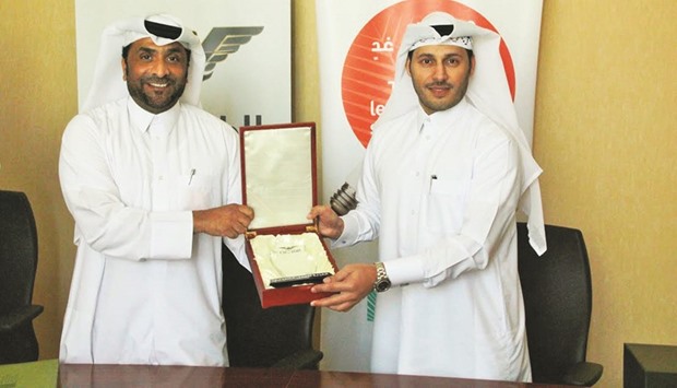 Ahmed al-Khulaifi, a member of the Al Fazaa Volunteers, with Meshal al-Shamari after the signing ceremony.