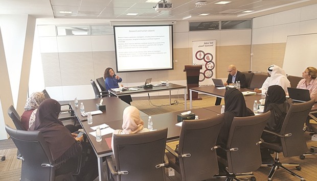 QU students participate in a discussion at the Qatar Genome Programme internship.