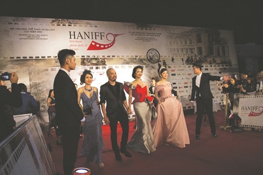 Vietnamese actress Giang My (third right) walks with fellow artistes as she arrives at the Hanoi International Film Festival yesterday.