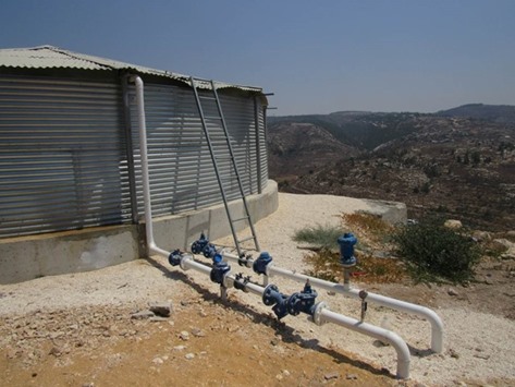 A view of the covered water reservoir and pipe system in the West Bank village of Al Jabu2019a.