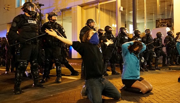 Demonstrators gesture in front of the police during a protest against the election of Republican Donald Trump in Portland, Oregon.