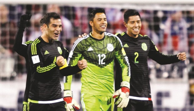 Mexico menu2019s national team defender Rafael Marquez (L), goal keeper Alfredo Talavera (C) and Hugo Ayala celebrate the teamu2019s 2-1 win against the US in Columbus. (AFP)