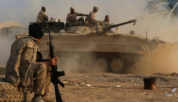Members of the Iraqi forces drive a BMP-1 infantry fighting vehicle