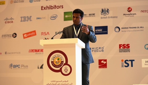 Abdulkhader delivering a presentation on cyberwarfare at the conference.