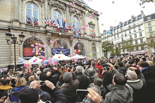 People release balloons in front of the city hall on the 11th arrondissement of Paris to mark the first anniversary of the terror attacks.
