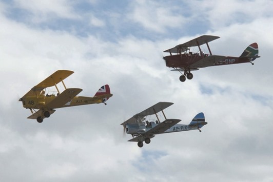 Biplanes representing Britain, Botswana and South Africa fly at the start on Saturday of a Vintage Air Rally over Sitia airport on the island of Crete, Greece.