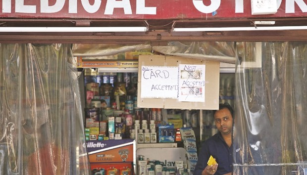 A notice is displayed at a medical store says it would not accept old Rs500 and Rs1,000 banknotes in Lucknow, yesterday.