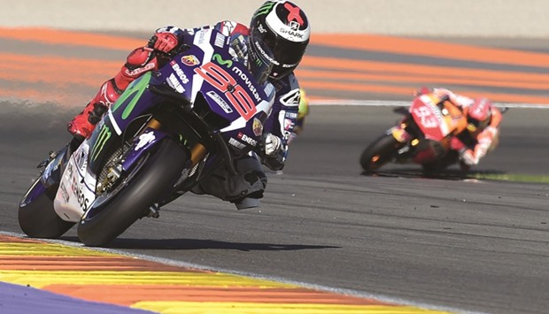 Yamahau2019s Jorge Lorenzo held off world champion Marq Marquez (right) of Honda to win the Valencia Grand Prix at the Ricardo Tormo racetrack in Cheste, Spain, yesterday. (AFP)