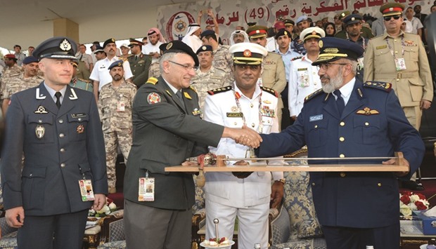 Chief of Staff of the Qatar Armed Forces HE Lieutenant-General Ghanem bin Shaheen al-Ghanem (right) greets CISM Sport Committee u2014 Shooting president Colonel Bruno Wolfensberger in presence of CISM president A Hakeem al-Shino at the opening ceremony of the 49th CISM World Military Shooting Championship yesterday. PICTURES: Thajudheen