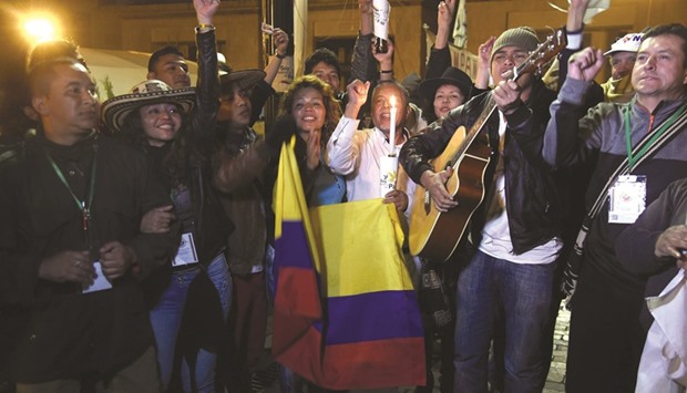 People celebrate on Bogotau2019s main square after the Colombian government and Farc signed a new and revised peace deal to end 52 years of civil war.
