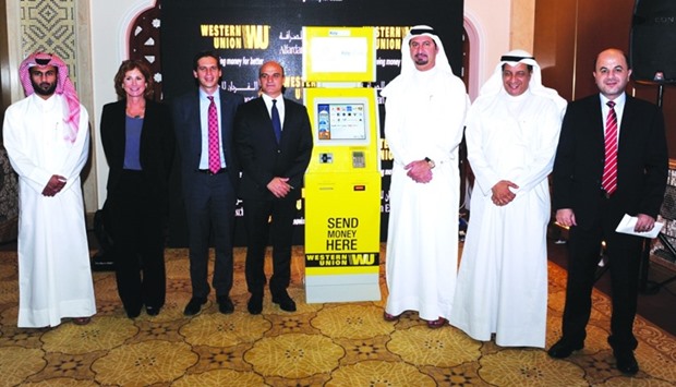 Alfardan Exchange president Fahad Alfardan (third right) and Western Union Middle East regional vice president Hatem Sleiman (fourth left) led the unveiling of one of the 80 self-service money transfer kiosks yesterday. PICTURE: Shemeer Rasheed