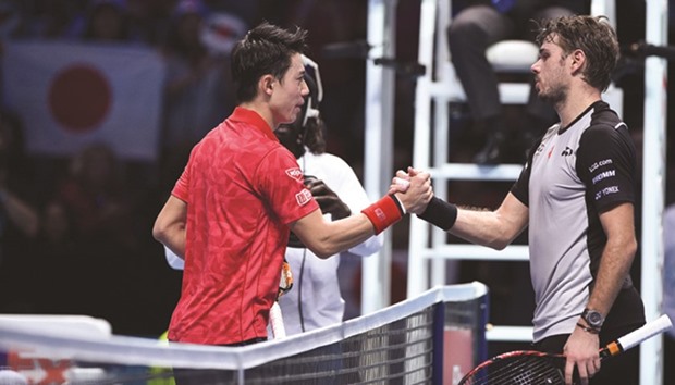 Japanu2019s Kei Nishikori (left) shakes hands with Switzerlandu2019s Stan Wawrinka after winning their round robin stage match at the ATP World Tour Finals in London yesterday. (AFP)