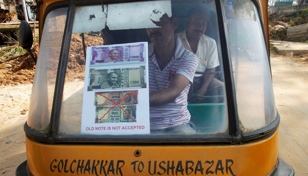 A driver displays a notice on the windscreen of his auto-rickshaw stating the refusal to accept old Rs500 and Rs1,000 banknotes in Agartala, yesterday.