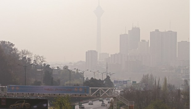A general view shows the Milad telecommunications tower in the distant behind a blanket of brown-white smog as the first of the winteru2019s heavy pollution hit in Tehran yesterday.